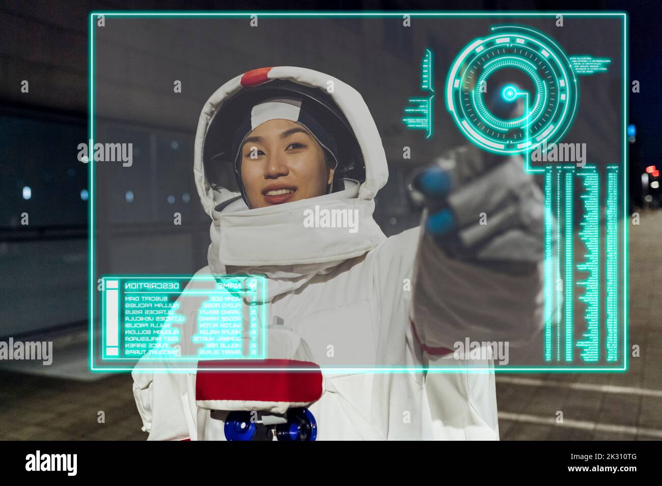 Young woman wearing astronaut costume touching device screen Stock Photo
