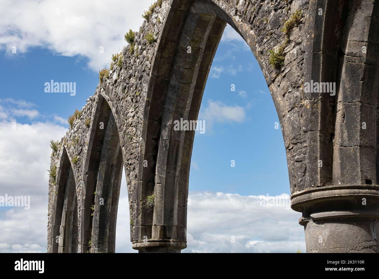 Ruined stone arches of church on sunny day Stock Photo