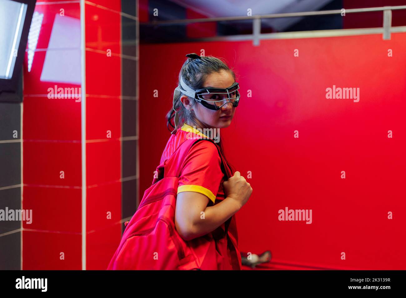 Lacrosse player with backpack standing in locker room Stock Photo Alamy