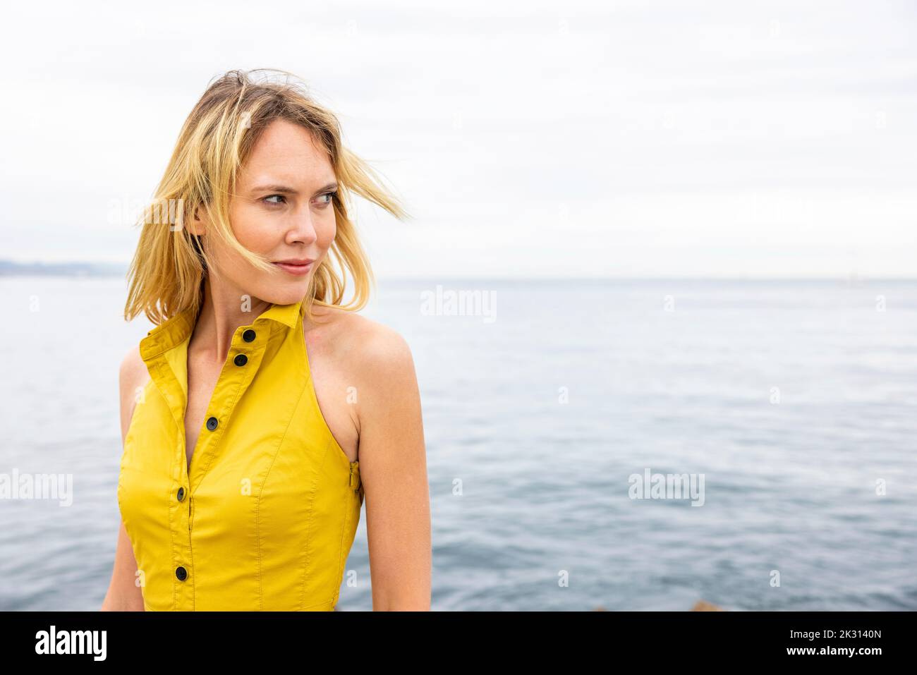 Blond beautiful woman in yellow hi-res stock photography and images - Alamy