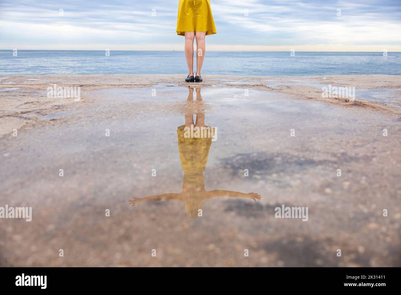 Woman with reflection on promenade Stock Photo