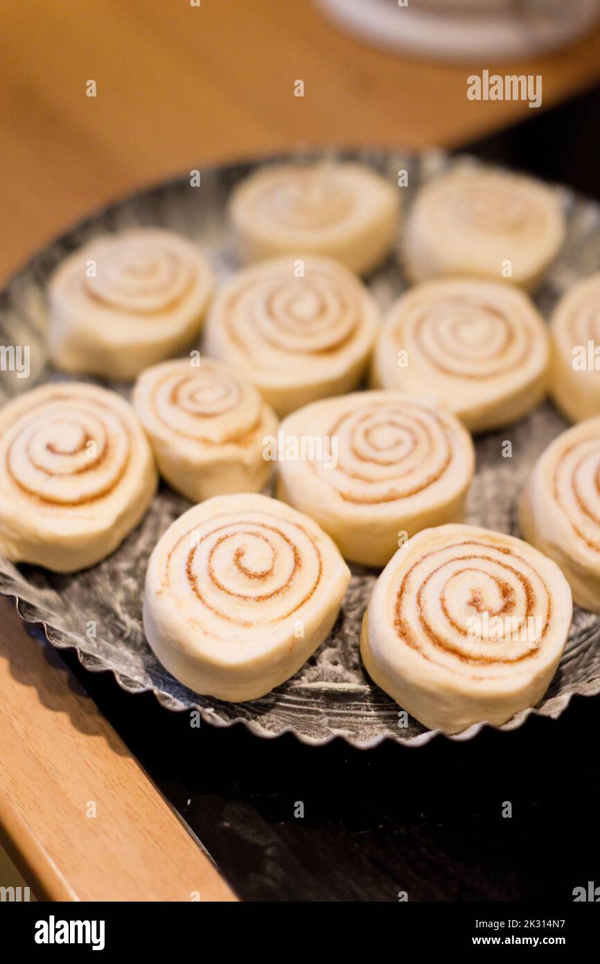 Raw cinnamon buns ready for baking Stock Photo