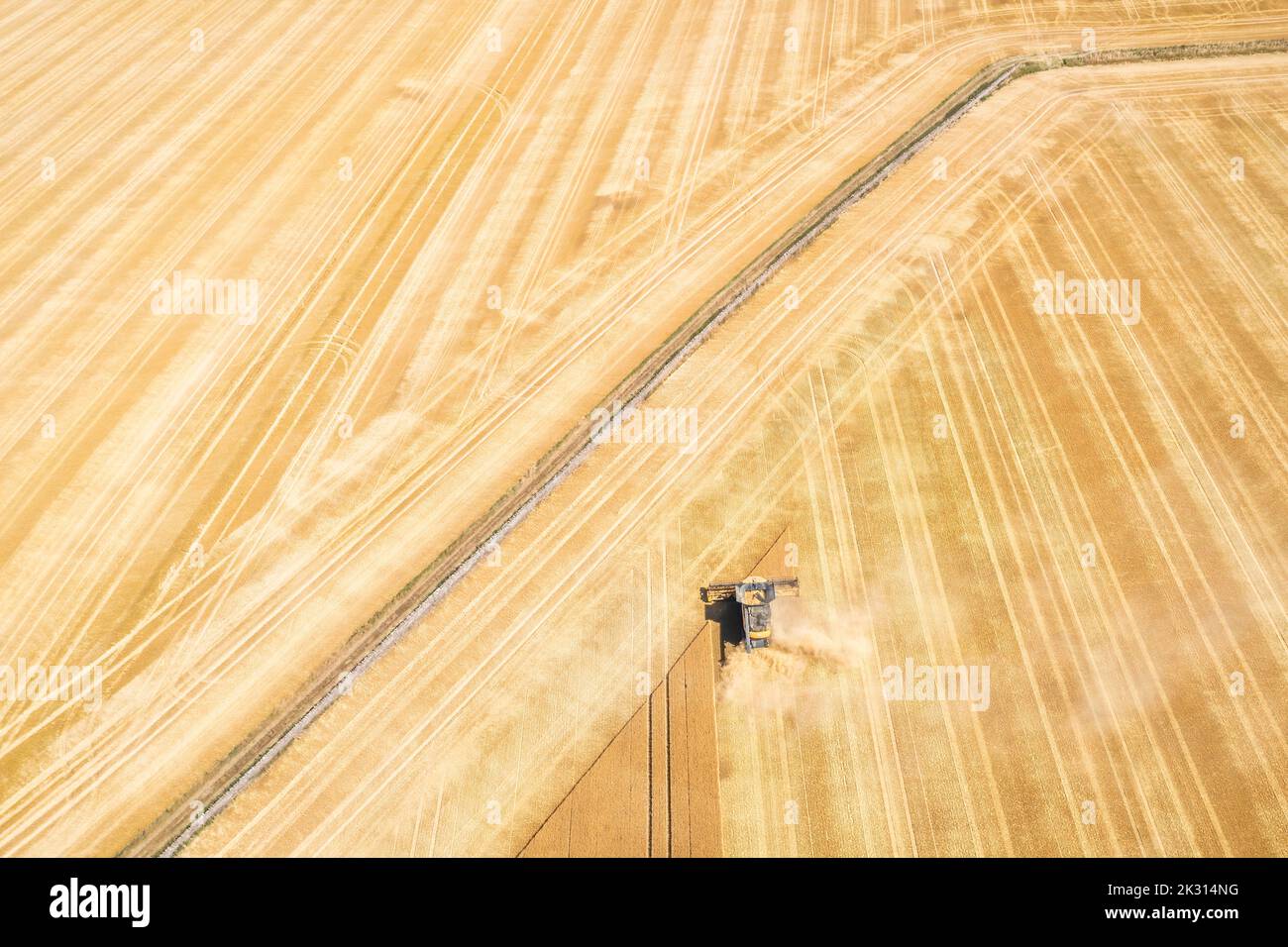 Aerial view of combine harvester in vast wheat field Stock Photo - Alamy