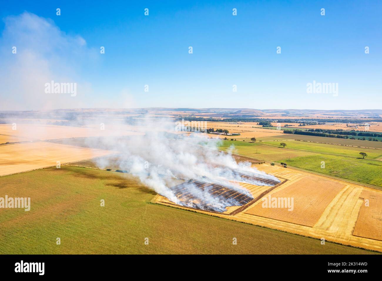UK, Scotland, Aerial view of burning wheat field Stock Photo