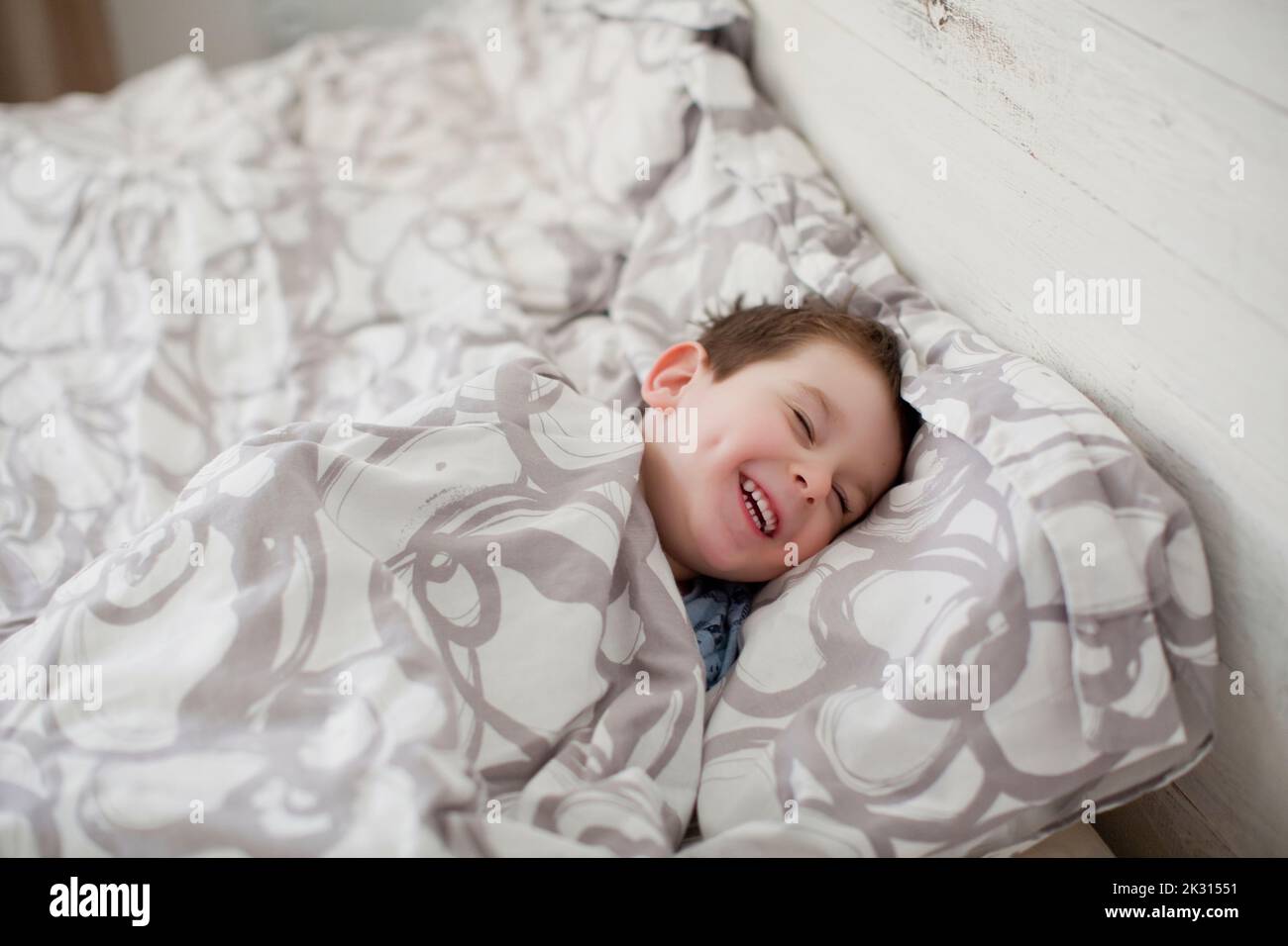 Happy boy enjoying bedtime at home Stock Photo