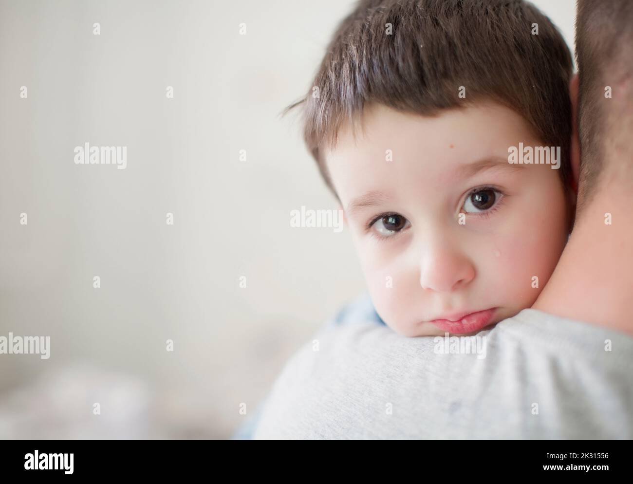Father carrying sad boy Stock Photo Alamy