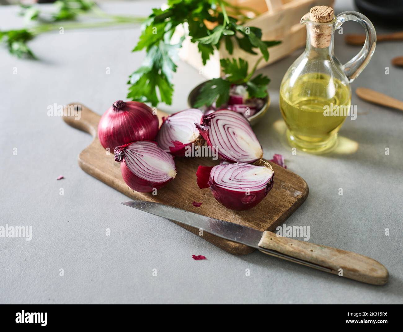 Kitchen knife, halved onions and jug of olive oil Stock Photo Alamy