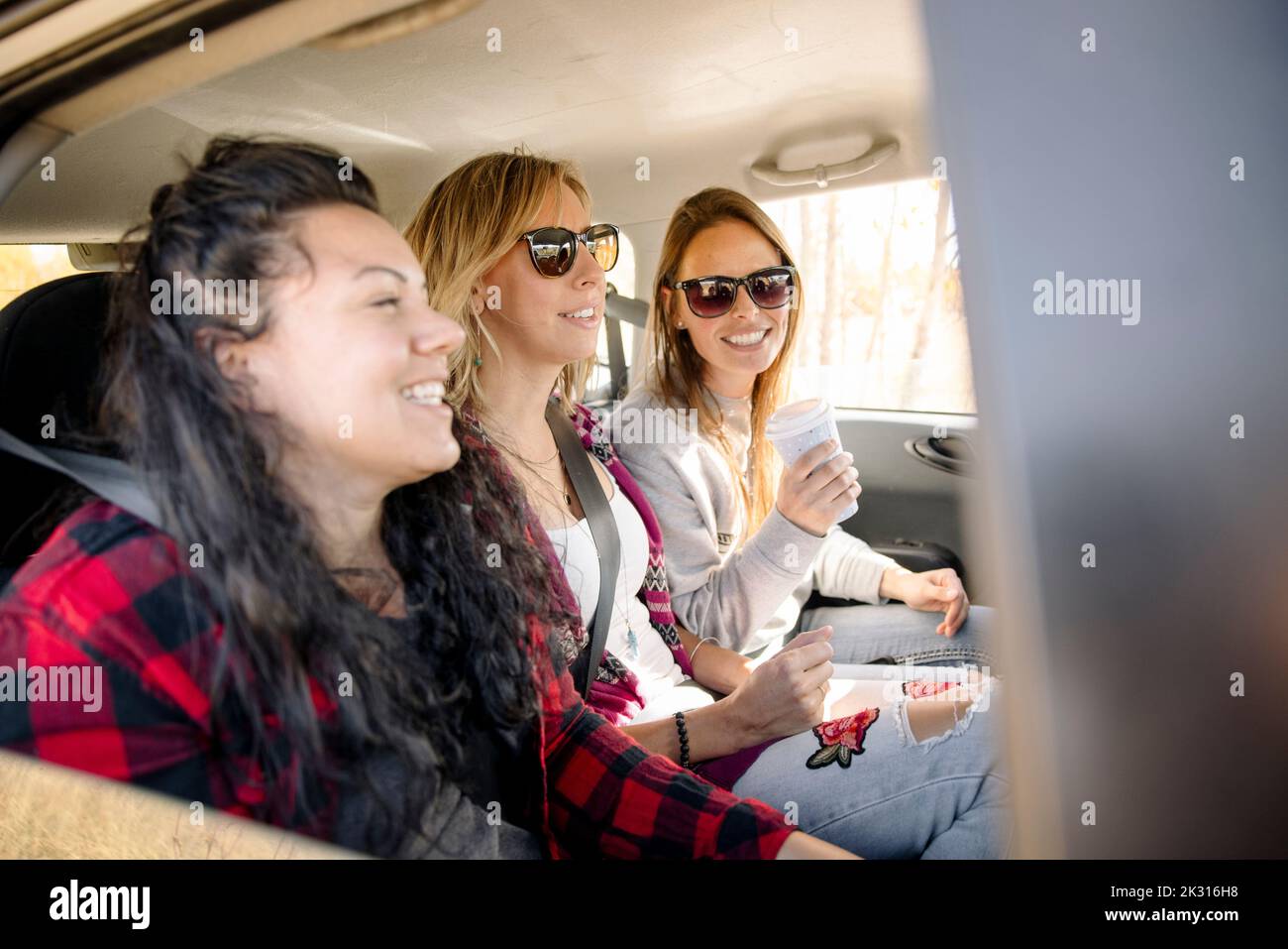 Women chatting in back of car Stock Photo