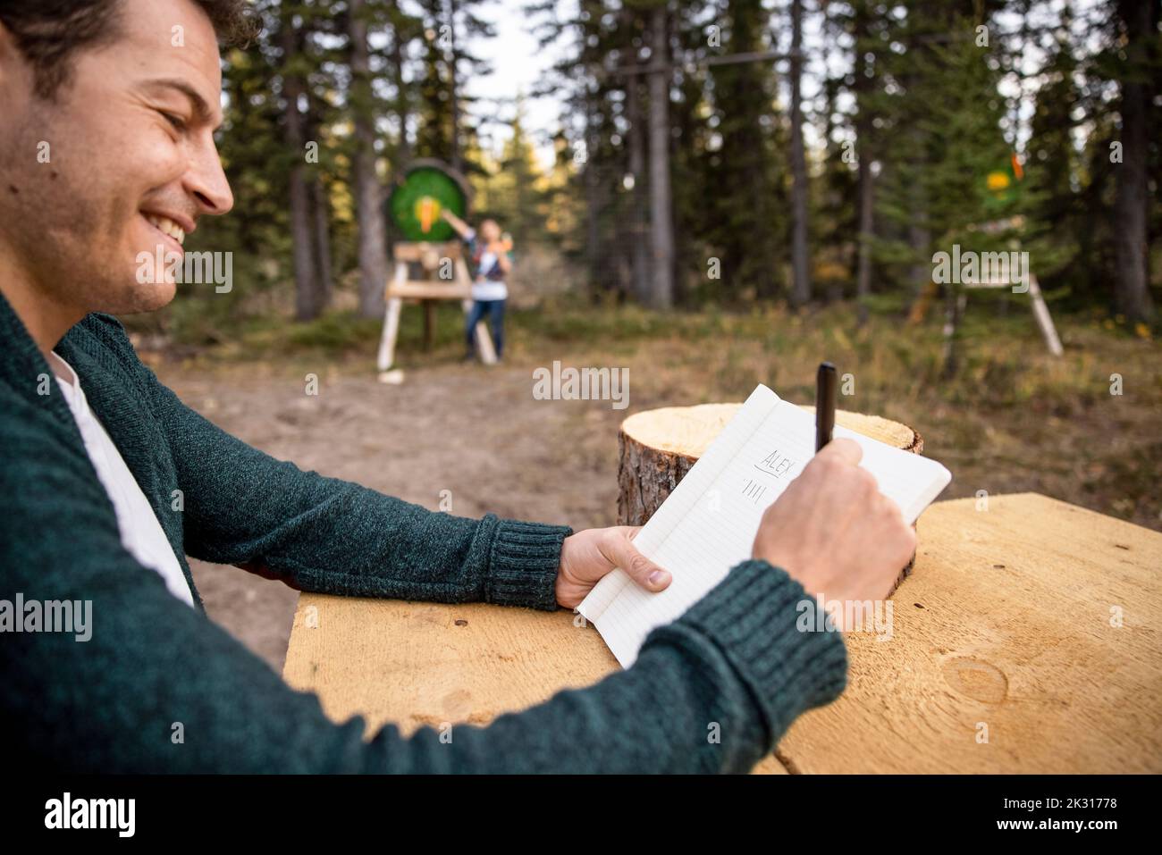 Man keeping score in axe throwing competition Stock Photo Alamy