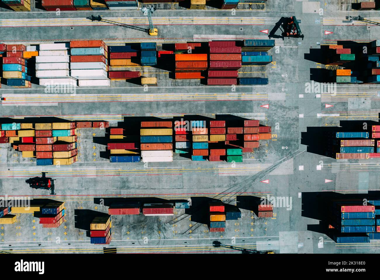 Aerial drone top down view of containers spread across a busy port, logistic and international trade concept Stock Photo
