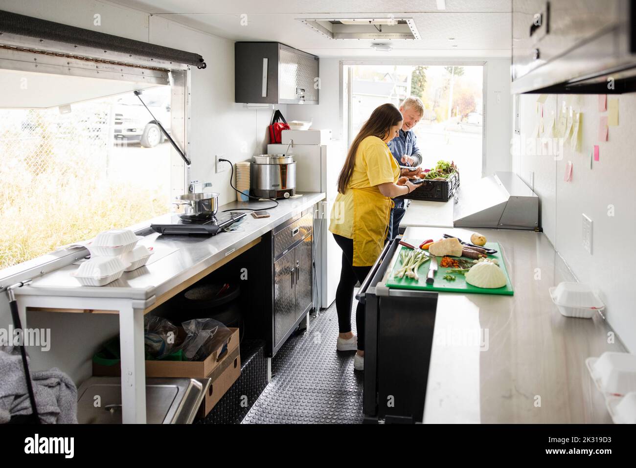 Food truck worker and delivery man checking vegetables Stock Photo Alamy