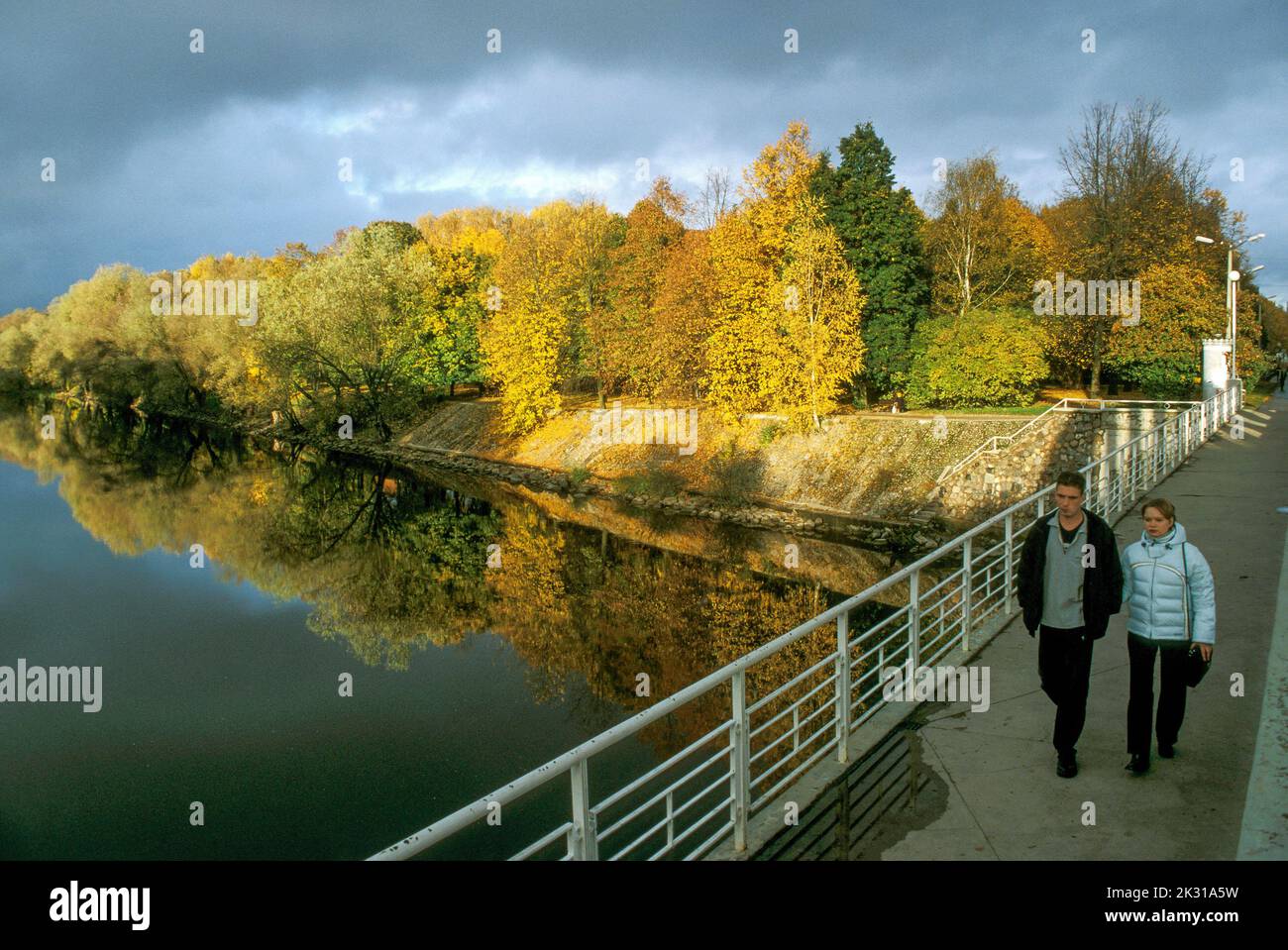 Strolling across the Emajogi River at Tartu, Estonia on an autumn evening Stock Photo