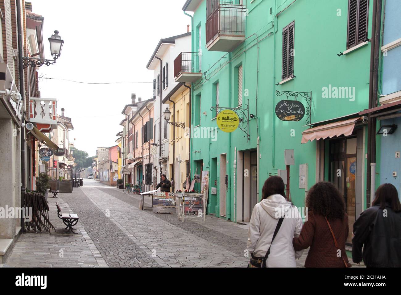 Cesenatico, Italy. Pedestrian alleyway edged by colorful buildings with small shops in the historical center. Stock Photo