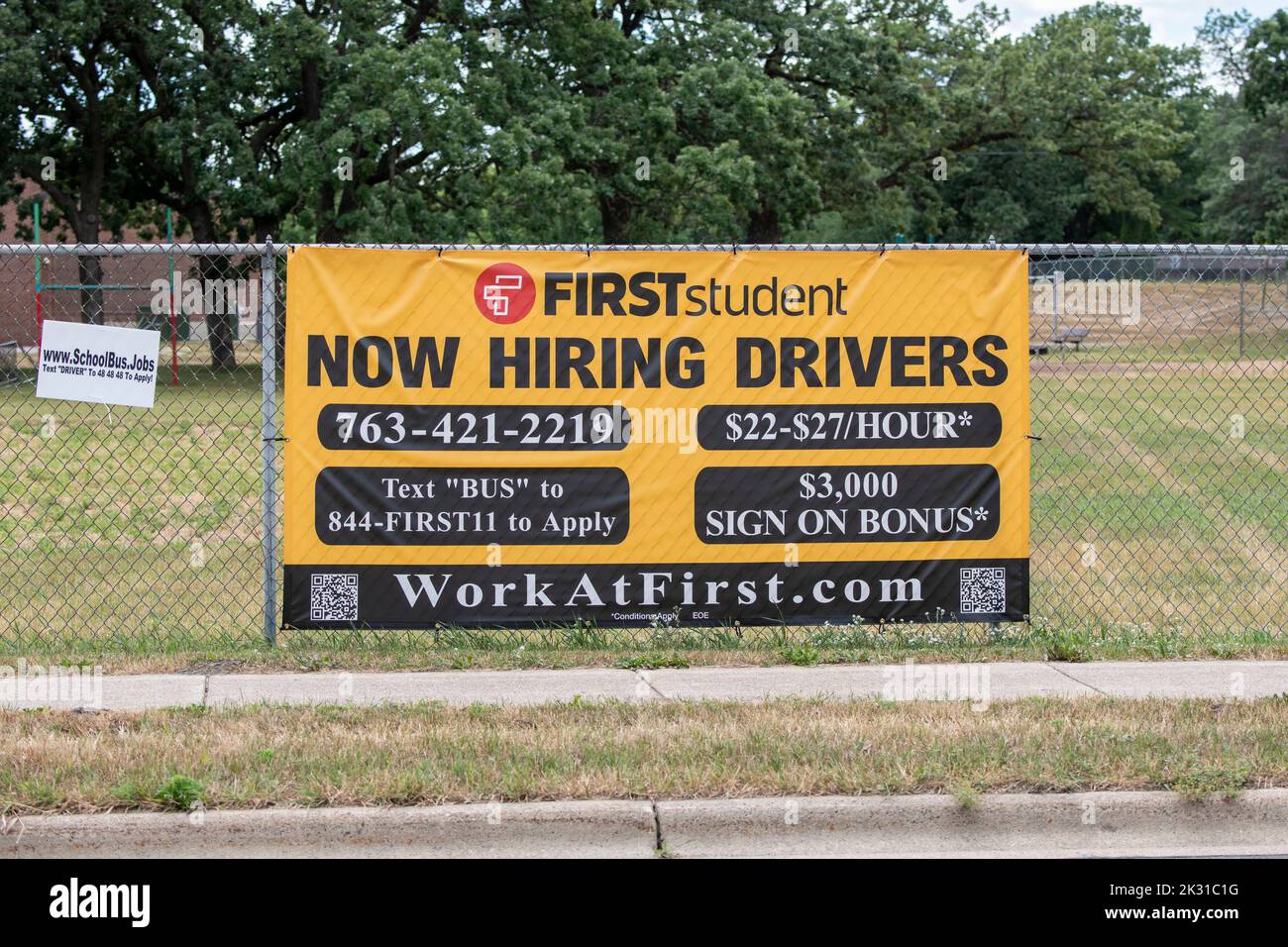 Mounds View, Minnestoa.  School bus company hiring drivers sign with good wages and a $3000 hiring bonus. Stock Photo