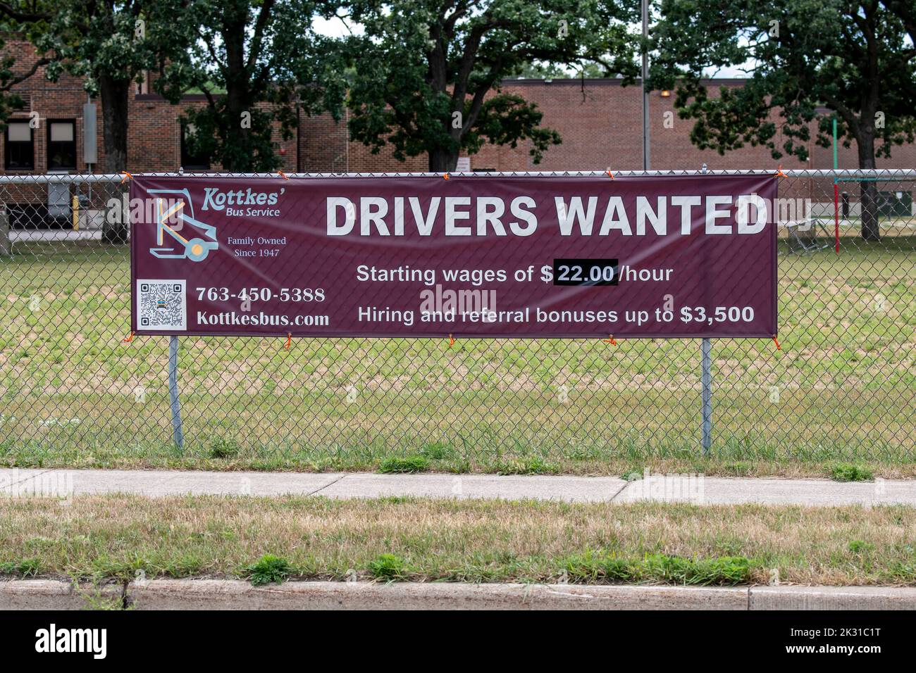 Mounds View, Minnestoa.  School bus company hiring drivers sign with good wages and a $3500 hiring bonus. Stock Photo
