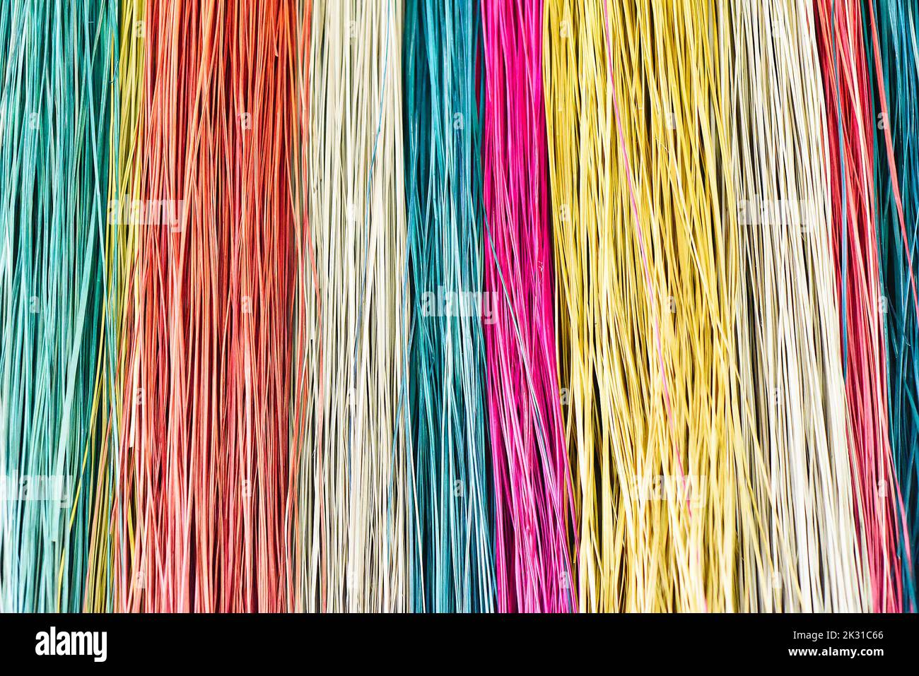 Many colorful prepared threads for weaving close up background Stock Photo