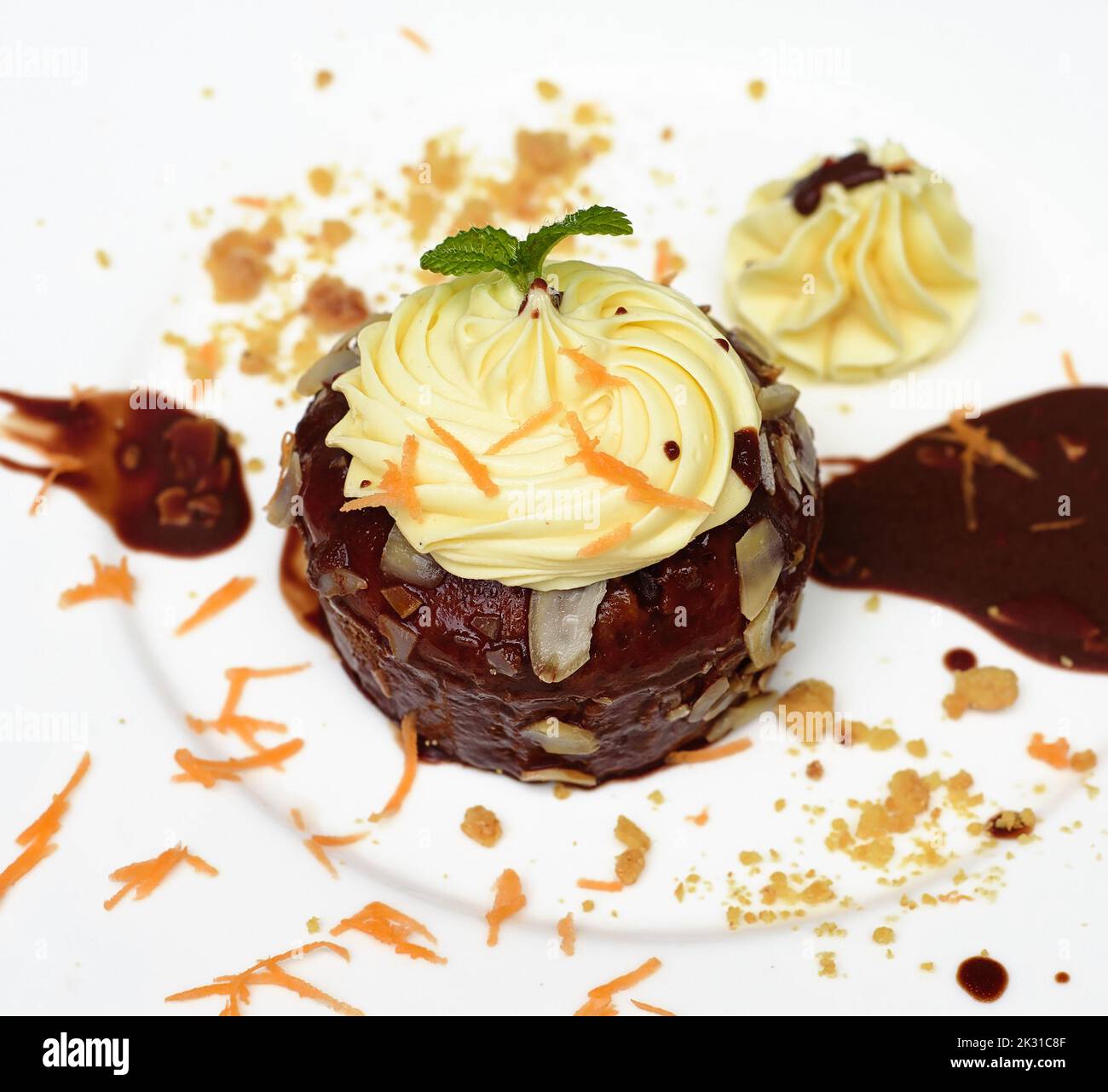Carrot chocolate cake on plate and black background Stock Photo
