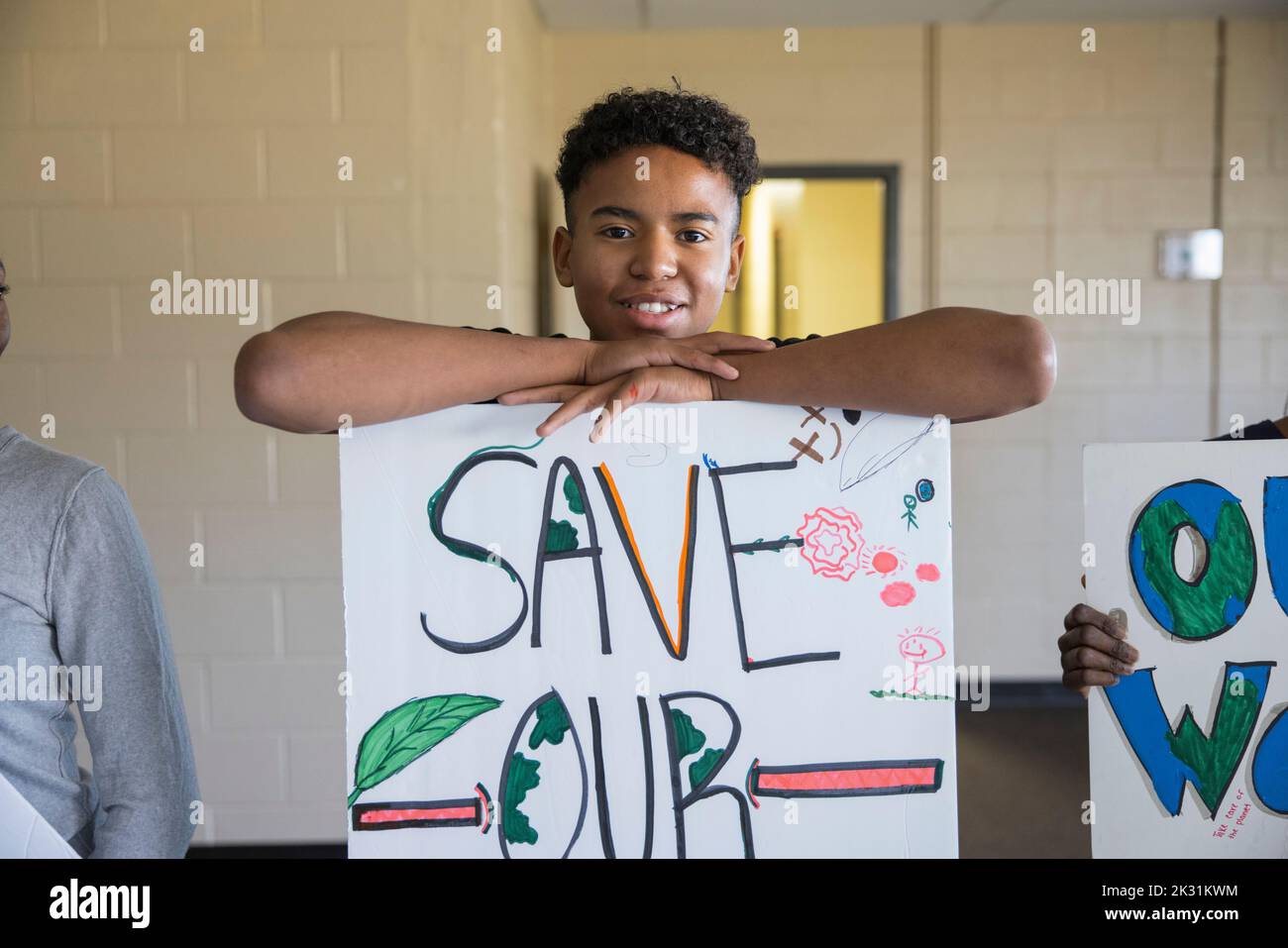 Portrait Confident Teen Male Environmental Activist With Poster Stock   Portrait Confident Teen Male Environmental Activist With Poster 2K31KWM 