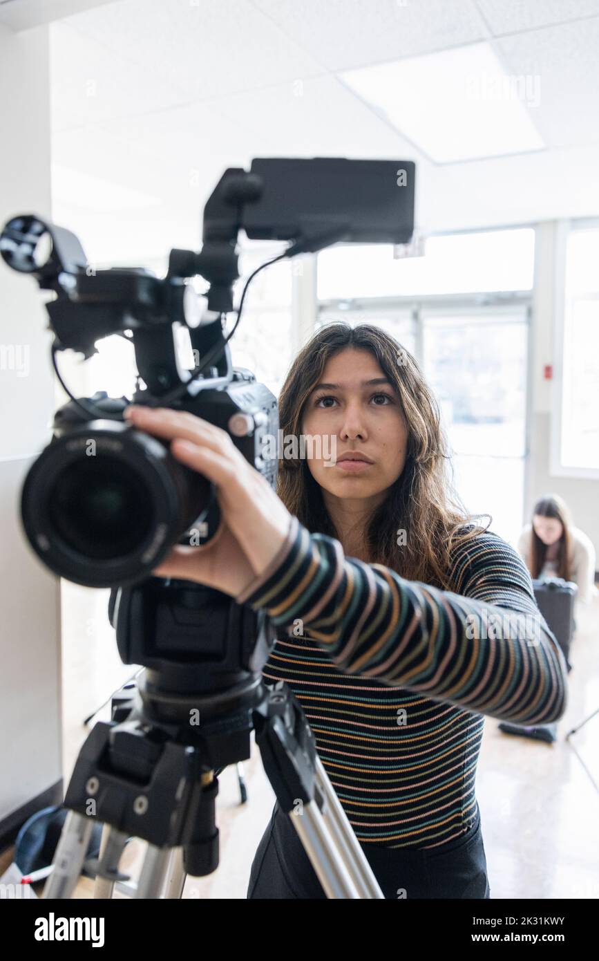 High school girl student operating video camera in classroom Stock