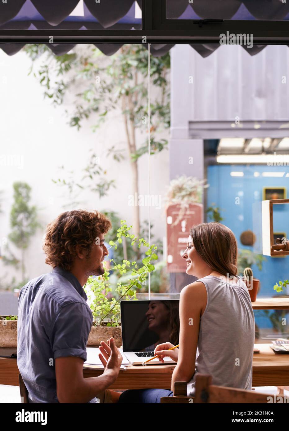 The coffee shop is a great place to study. two young students going