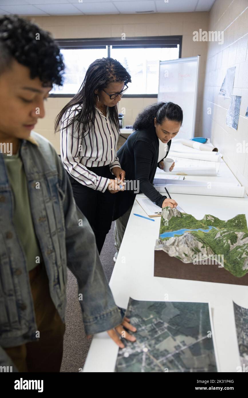 Community looking at urban planning maps and models Stock Photo