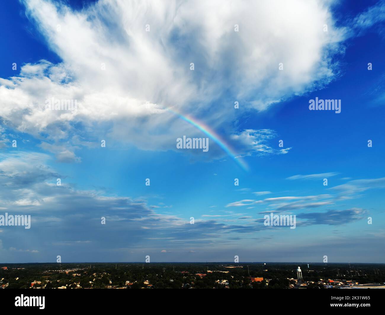 Rainbow Running Through a Blue Sky Stock Photo