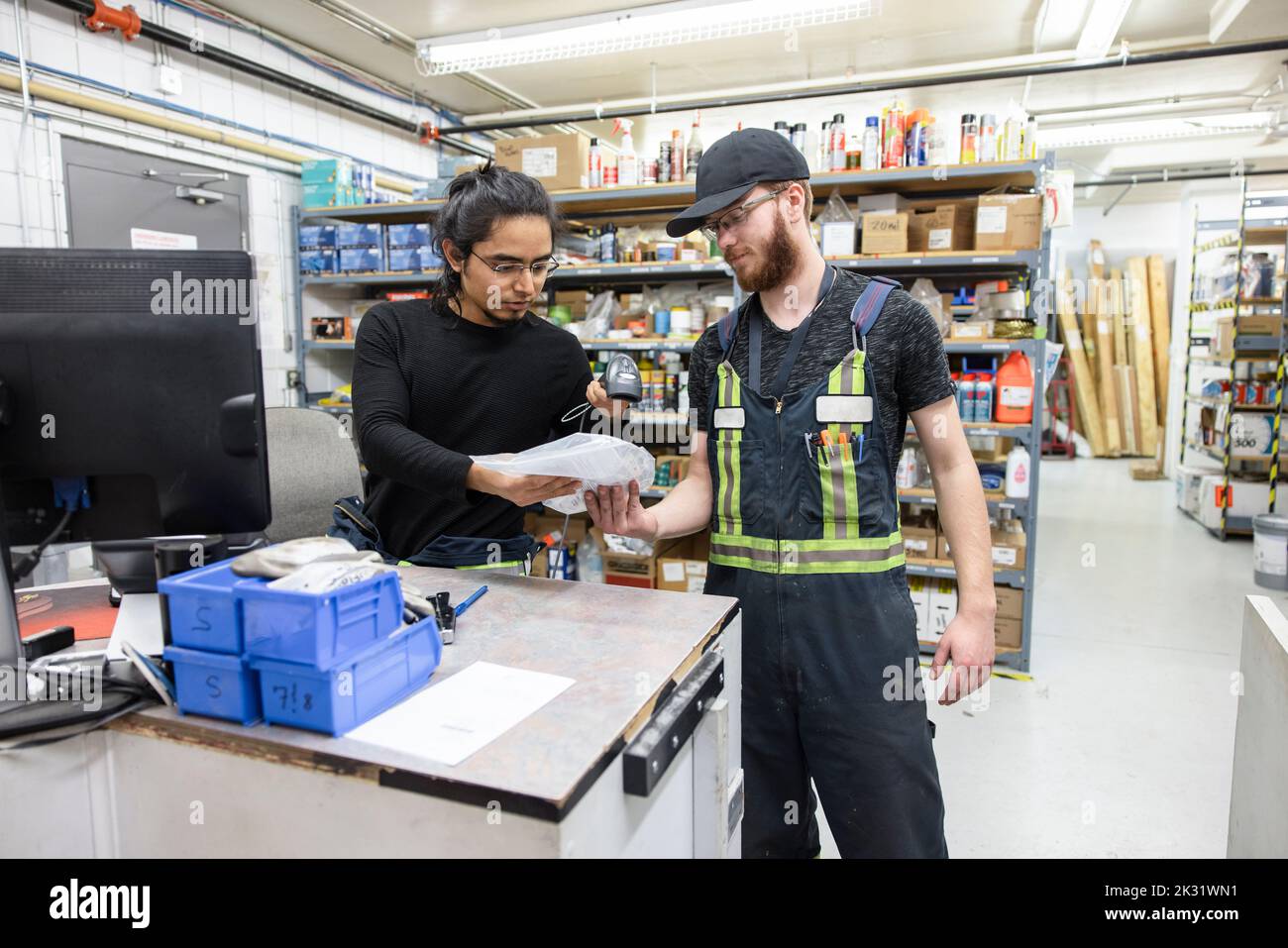 Technician scanning component in storeroom Stock Photo Alamy