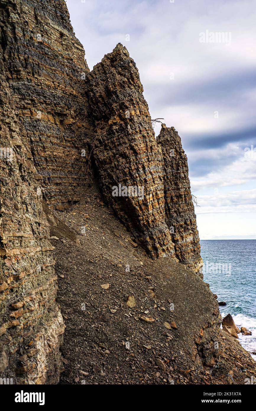 Geological rock layers over millions of years near the Mediterranean sea. Stock Photo
