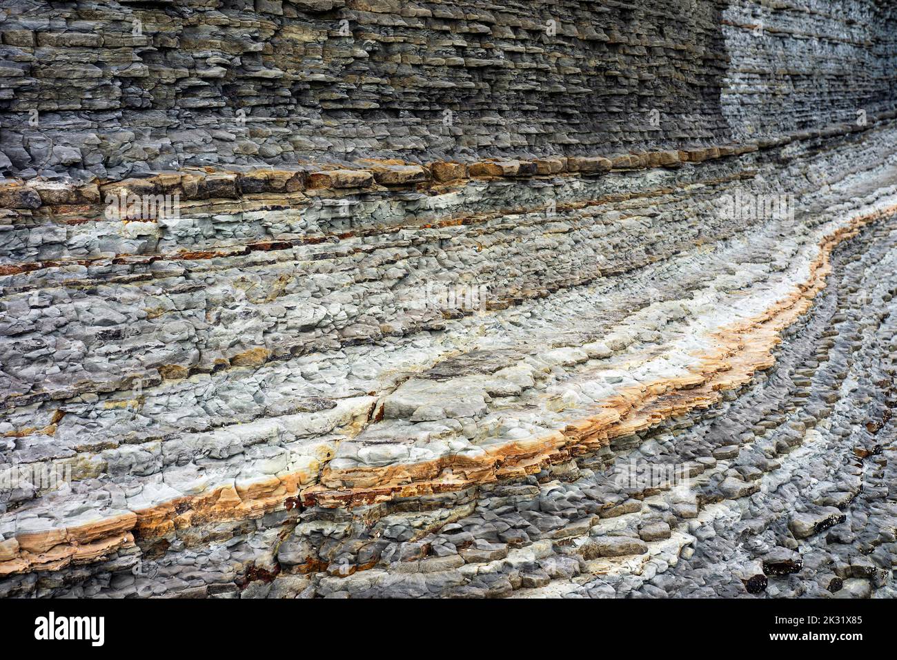 Geological rock layers exposed over millions of years. Stock Photo