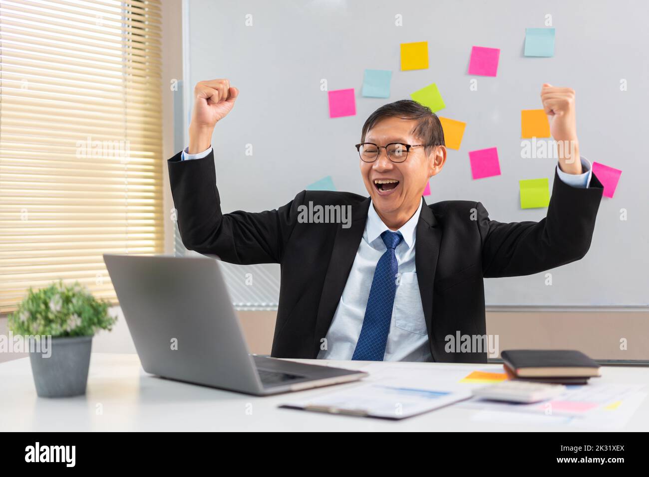 Happy young man raises arms hi-res stock photography and images - Alamy