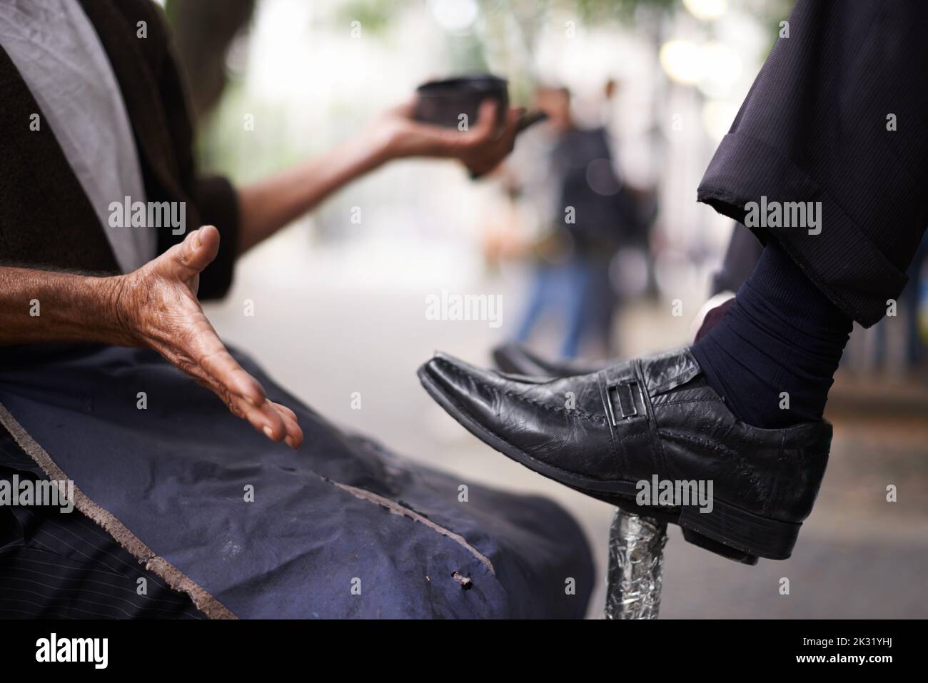 Keeping the businessmens shoes shiney. a shoe shiner shining a