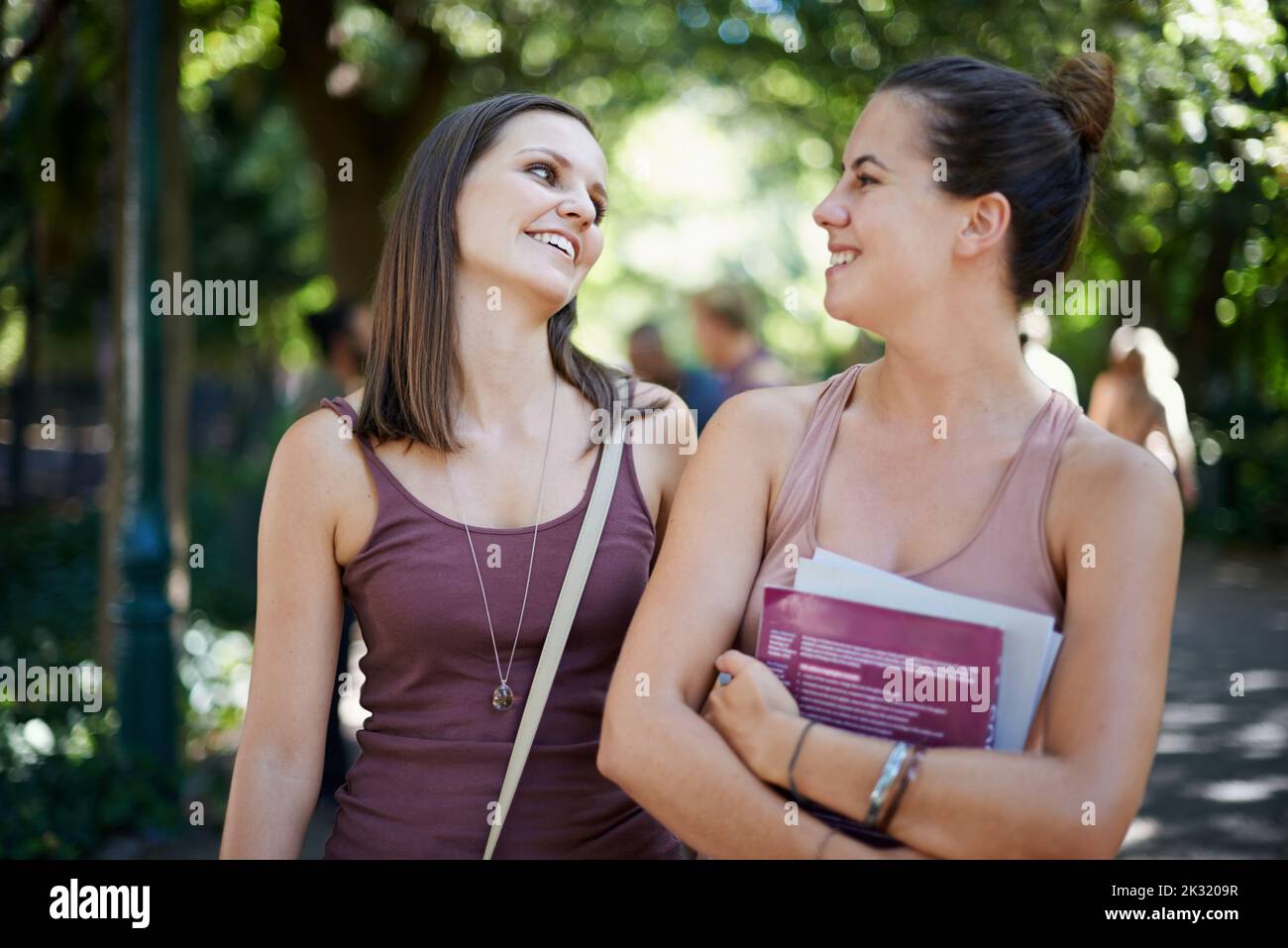 Friendship is a single soul living in two bodies. two female college students hanging out on campus. Stock Photo