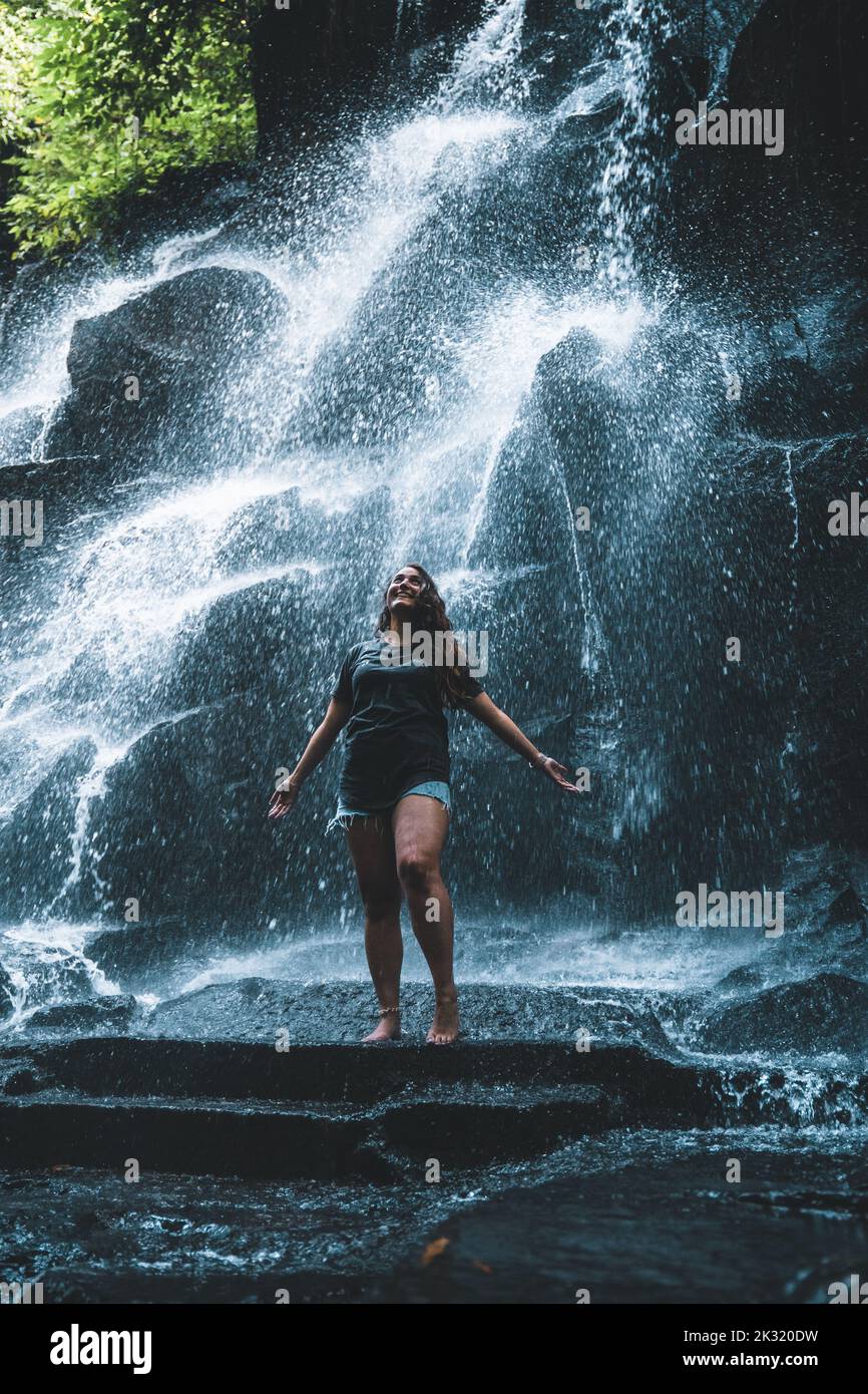 A Caucasian woman standing in front of waterfall Stock Photo - Alamy