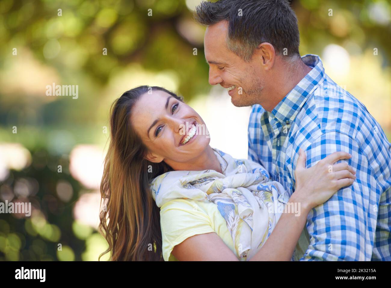 He makes me so happy. An affectionate couple outside in the summer sun. Stock Photo