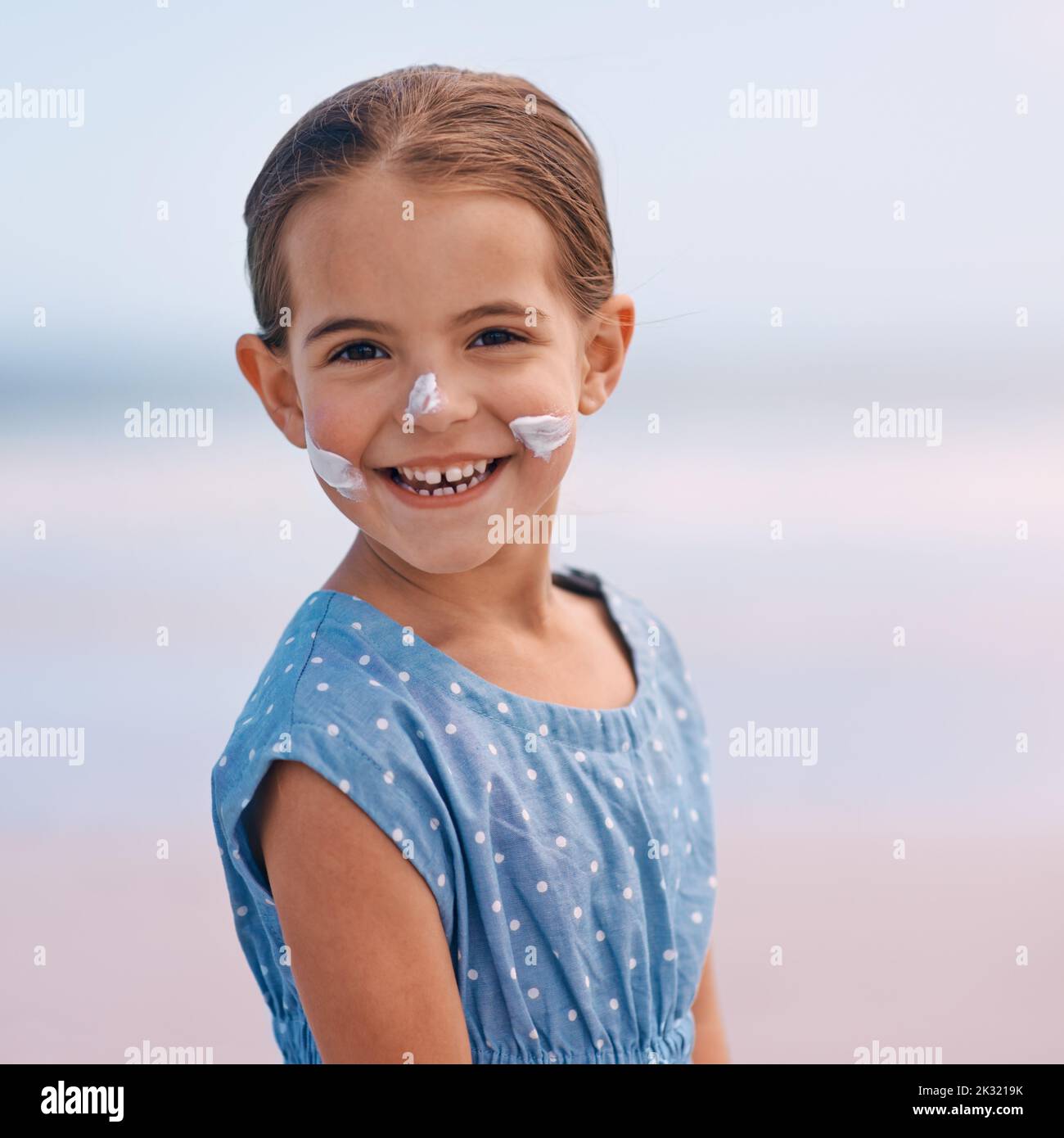 Shes safe with her sunscreen. Portrait of a smiling little girl with