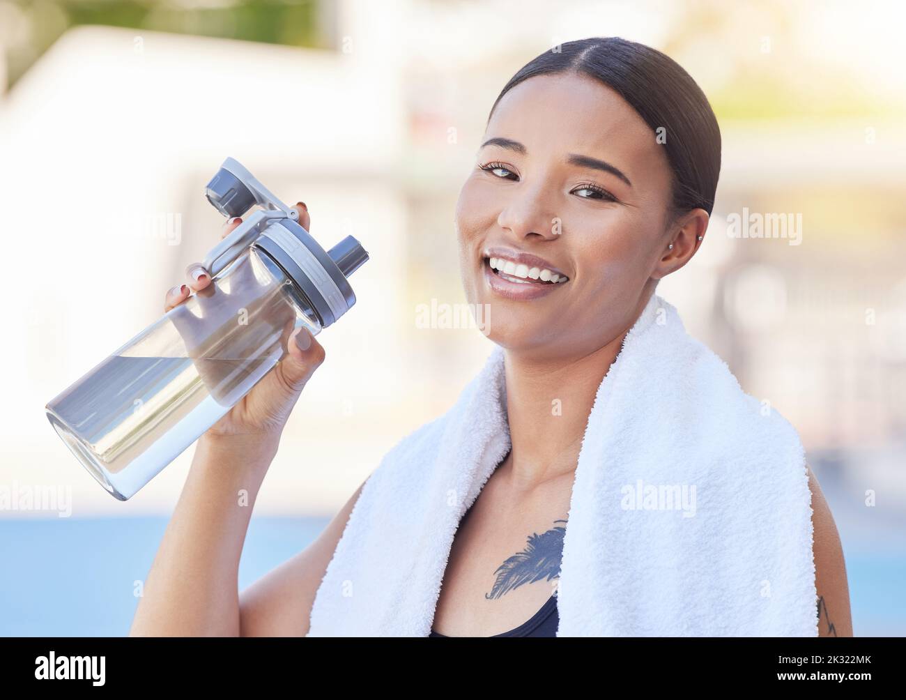 Woman, fitness and water bottle after workout, training and exercise on