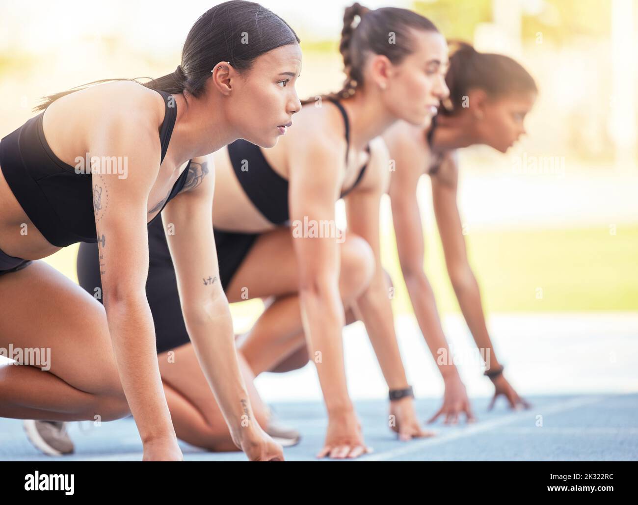 Women start sports race, running competition and marathon training, fitness event and challenge in outdoor stadium. Focus, mindset and group runners Stock Photo