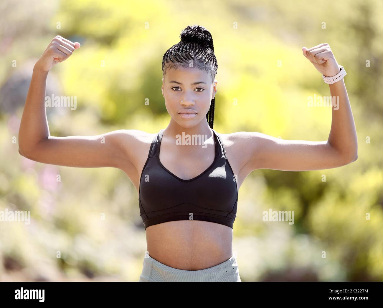 Fitness, strong arm muscles an black woman after a sports workout, training and exercise in nature. Portrait of a healthy female athlete with Stock Photo