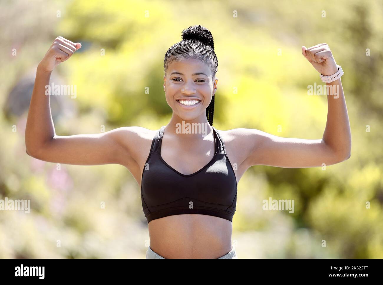 Sports woman with strong biceps doing exercise and training. Portrait of young black woman showing strength, fitness and muscles after exercising Stock Photo