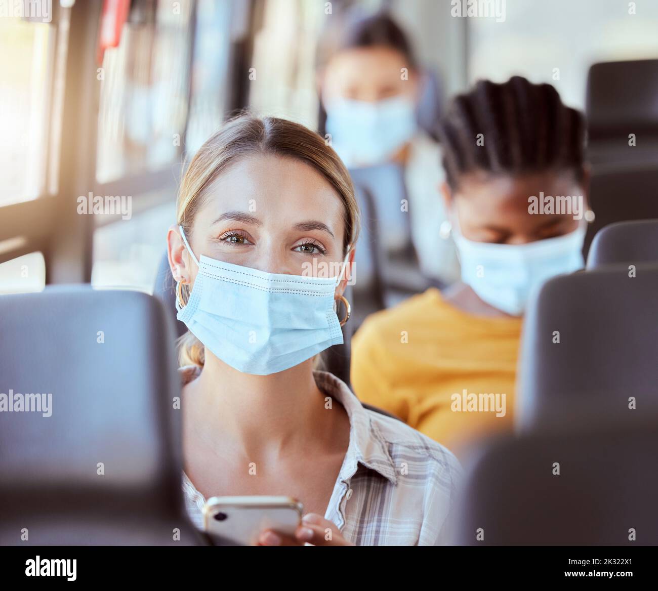 Woman, covid and mask on bus with phone for travel safety public transport commute. Portrait, health and healthcare female with ppe, corona protection Stock Photo