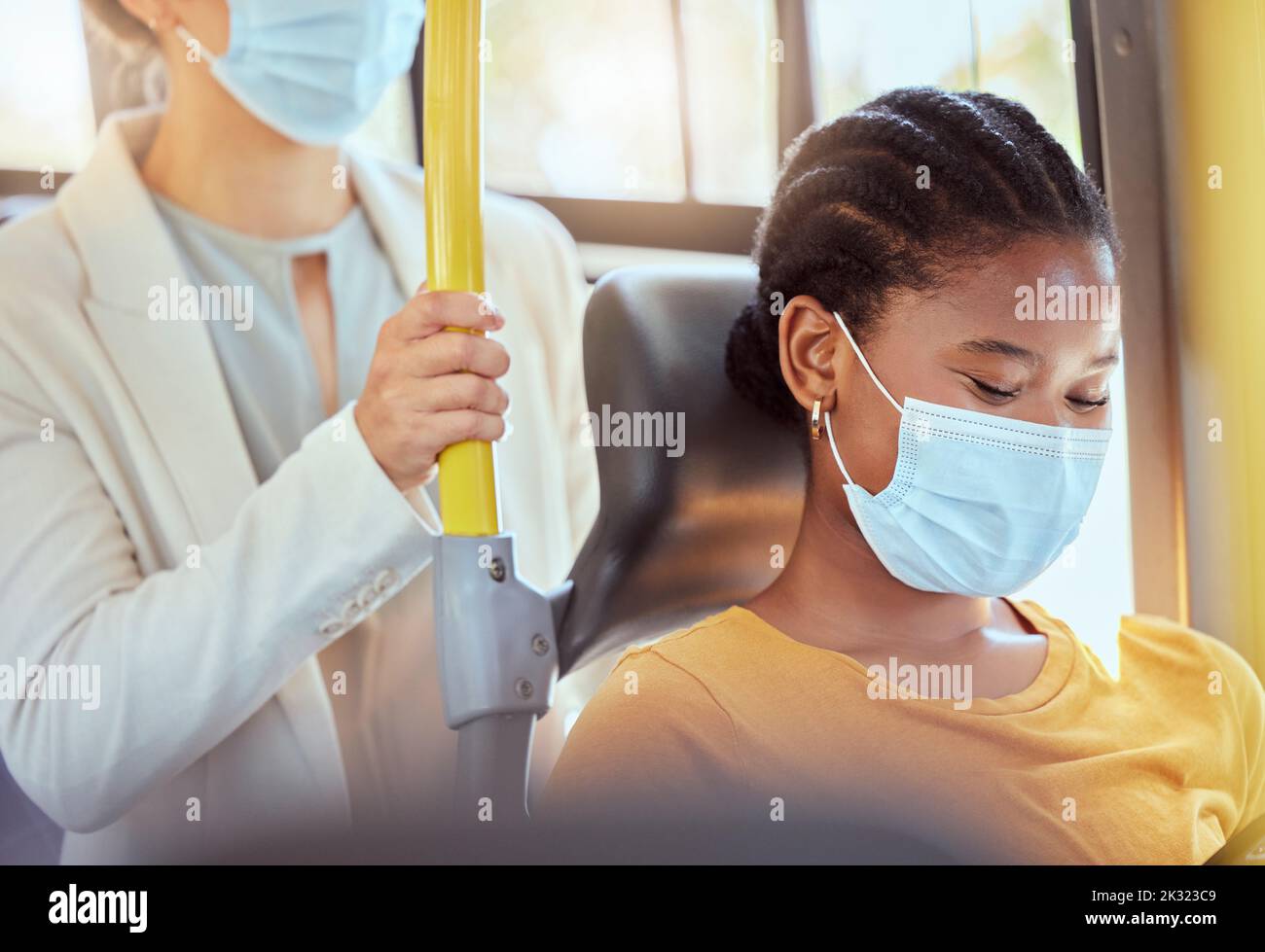 Covid, health black woman travel on bus smiling, social distancing for safety in pandemic virus. Happy women diversity of people on car transport Stock Photo