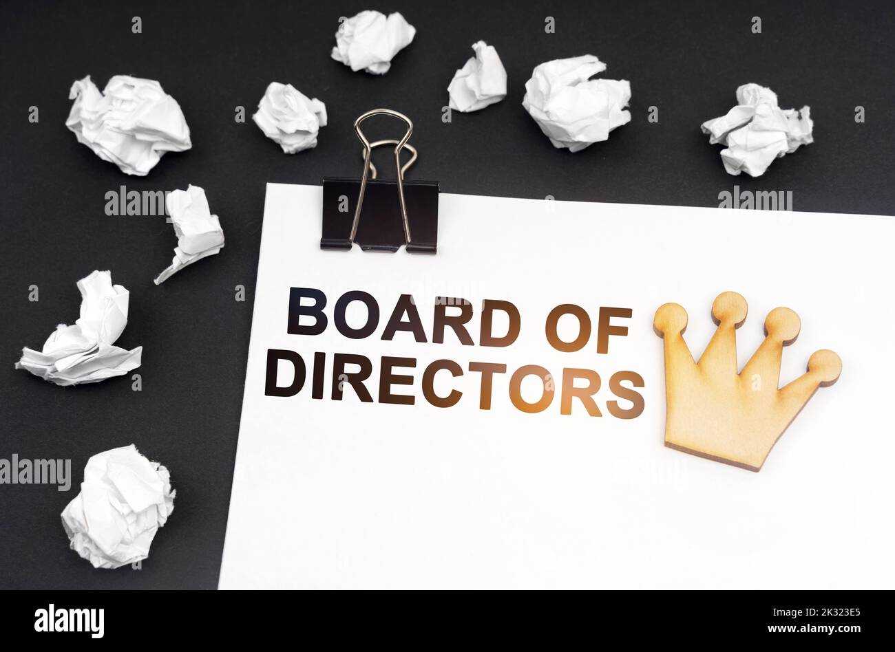 Business and finance concept. On a black background, crumpled paper and a sheet with the inscription - Board of Directors Stock Photo