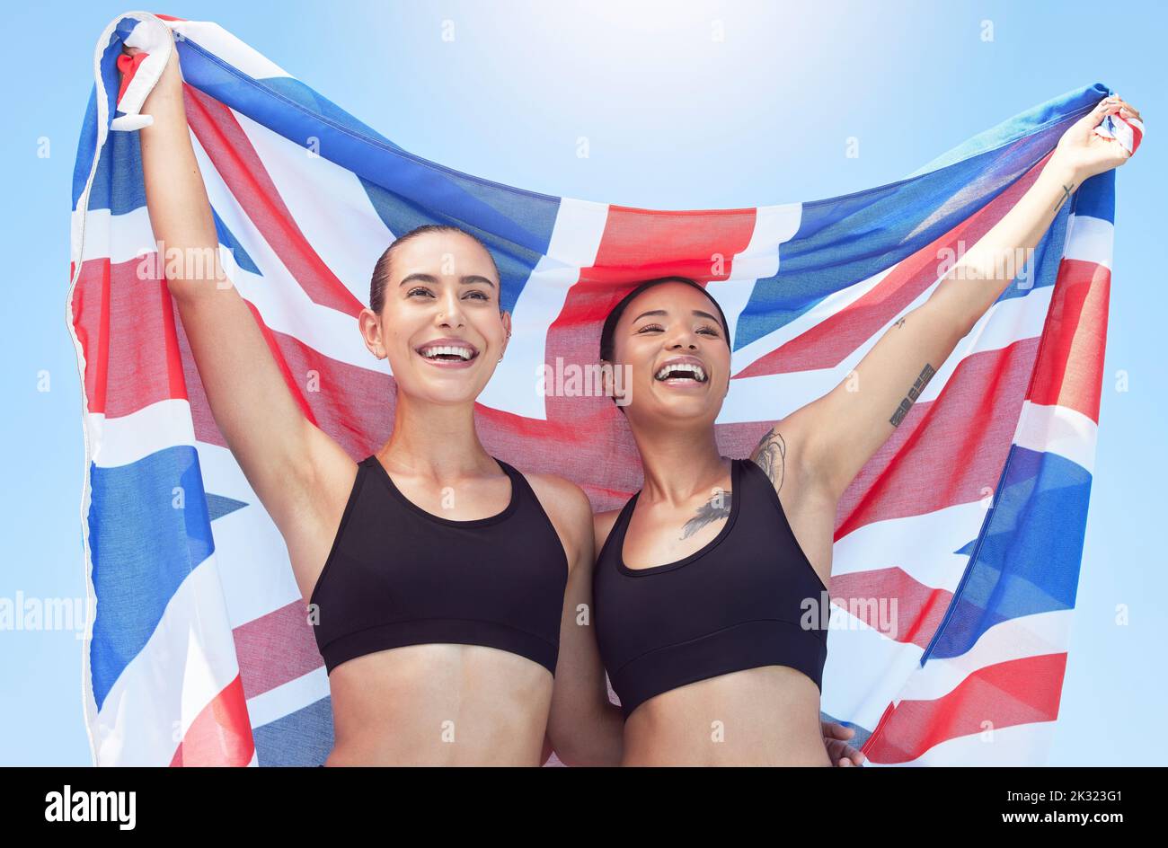 Sports women, athletes and british flag team winning celebration, event and international contest outdoor. Happy, excited and english united kingdom Stock Photo