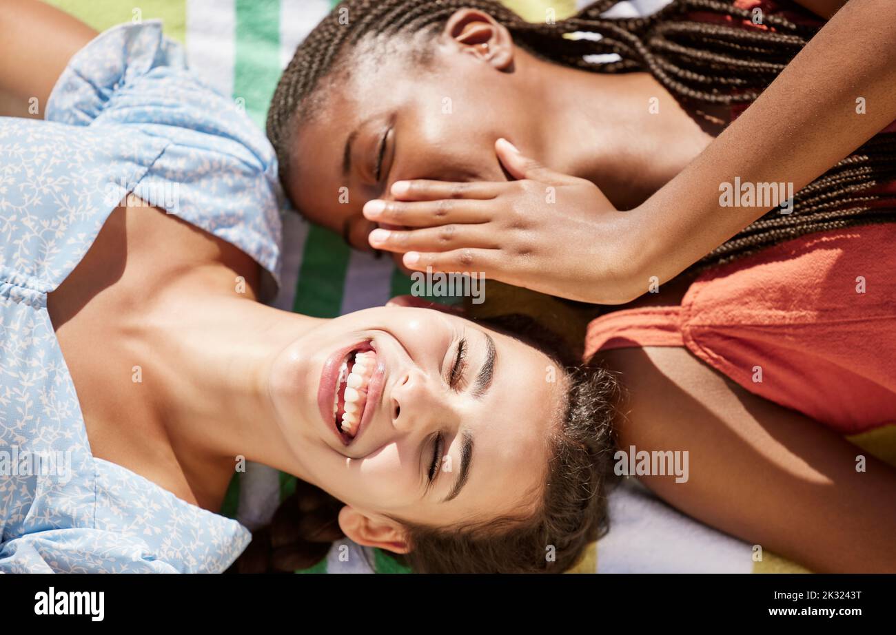 Whisper, secret and gossip with woman friends sharing stories with her girl friend outdoor from above. Laughing, quiet and funny with a young female Stock Photo
