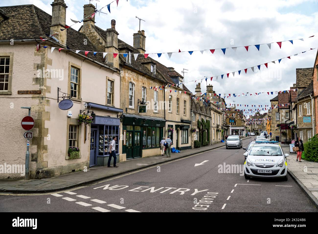 CORSHAM, UK: a person rides his bike in a street in Corsham, an old village in south of England on July, 17, 2015 in Corsham, UK Stock Photo