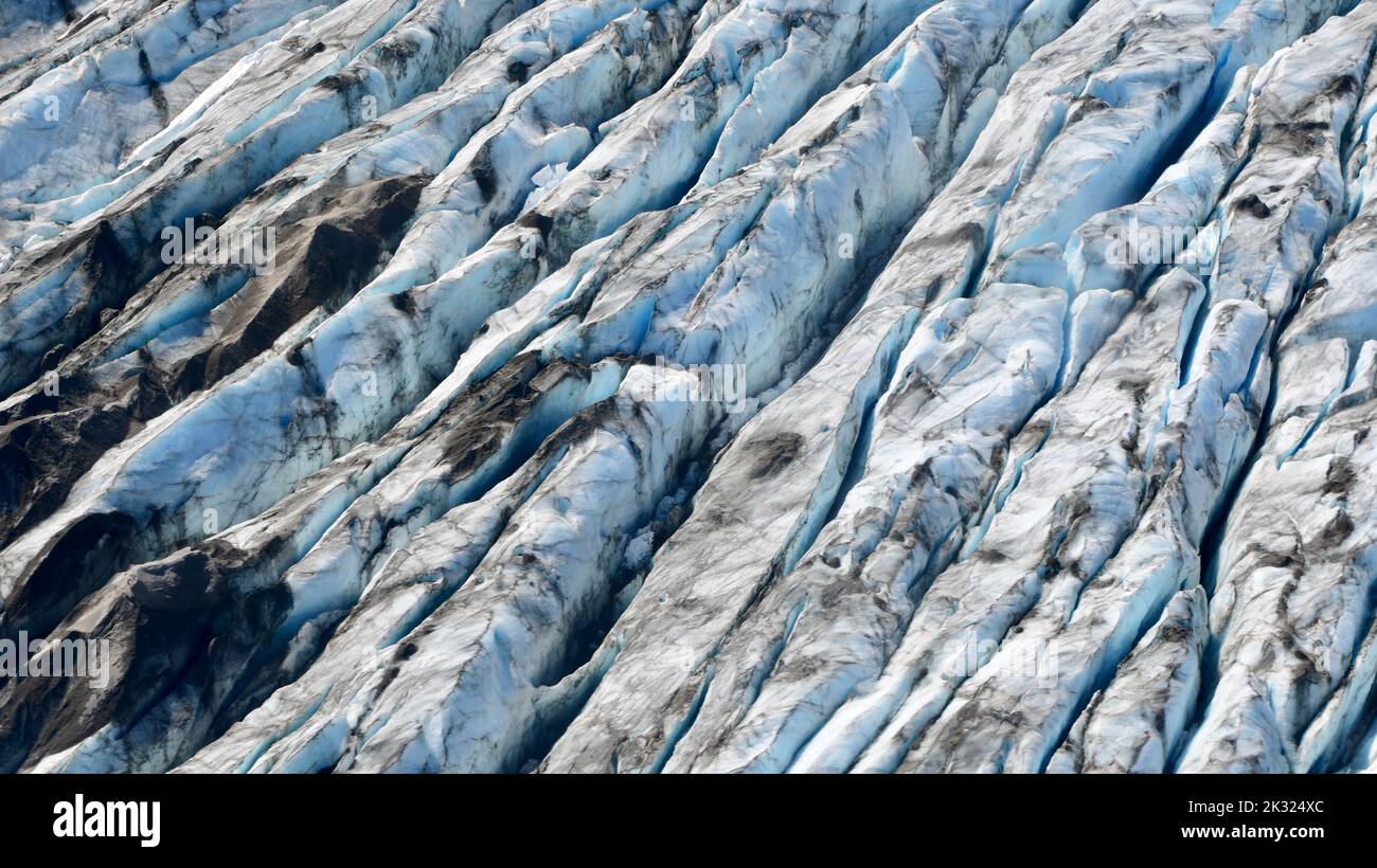 A closeup shot of broken-off icebergs dirt and debris on the lake of the Knik Glacier Stock Photo