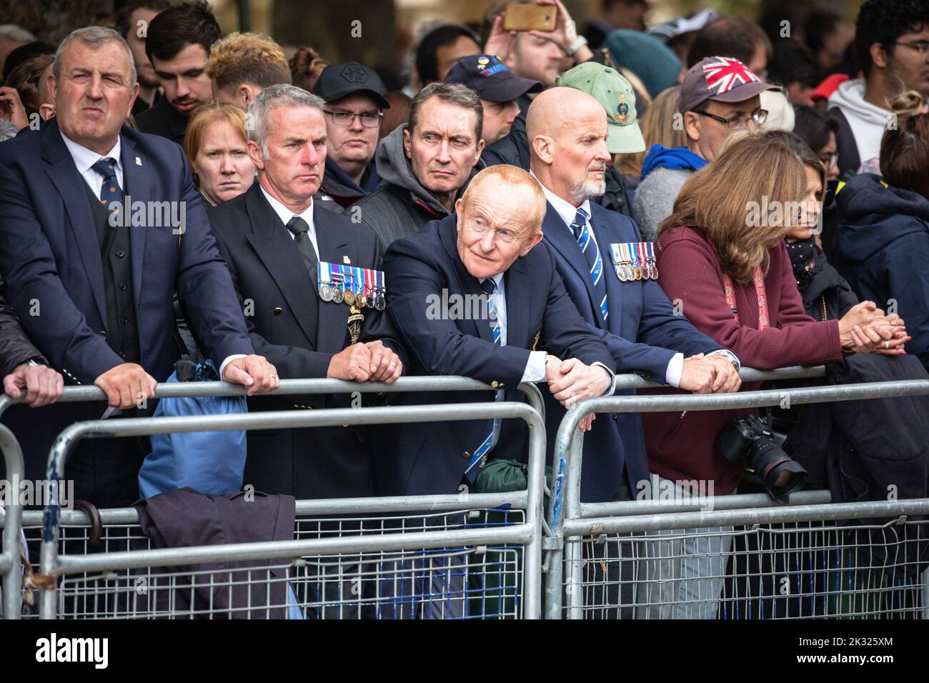 Soldiers and veterans watch the Queen Elizabeth II funeral procession in London following the Queen's death, England, United Kingdom Stock Photo