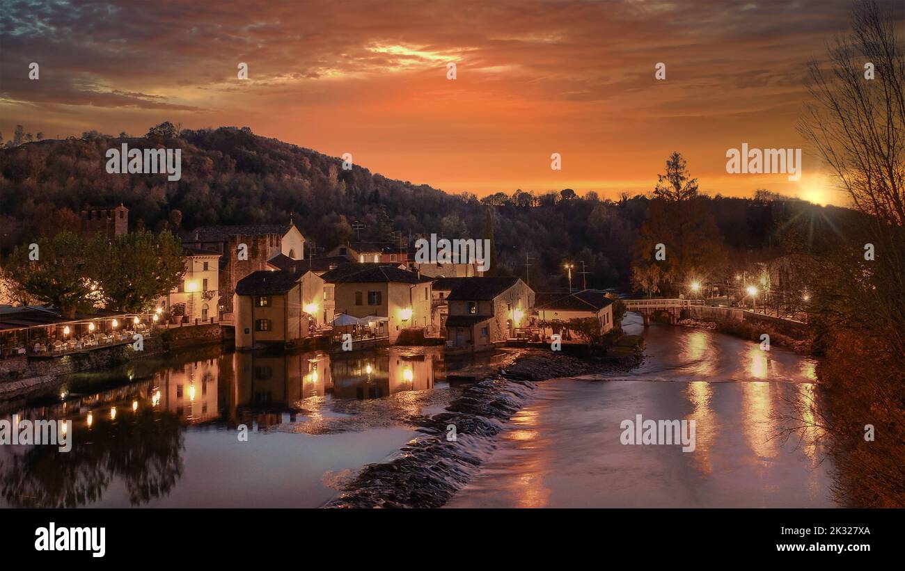 Panoramic and suggestive view of Borghetto (means small village) at sunset. Medieval village in northern Italy. Stock Photo