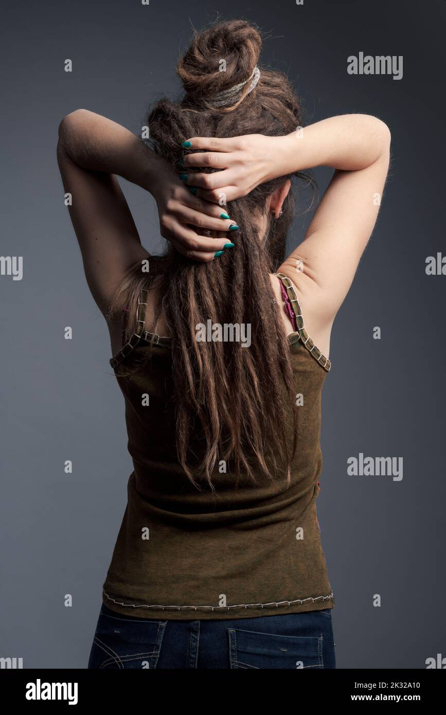 Closeup portrait of young woman, dreadlocks and long hair back view ...