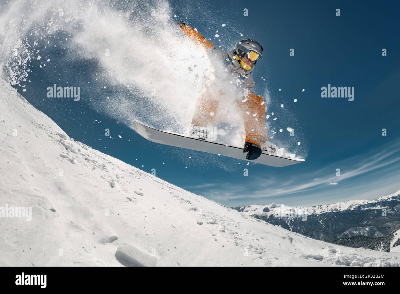 Professional snowboarder jump at off-piste ski slope. Extreme sports concept Stock Photo